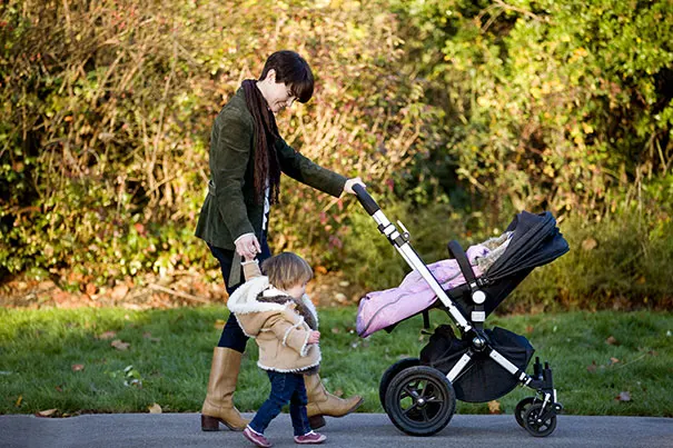 Mom walking outside with baby and toddler 