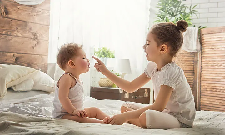 Baby playing with sister